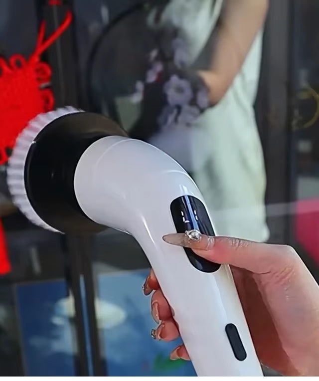 Hand holding a white and black handheld device with a blurred background